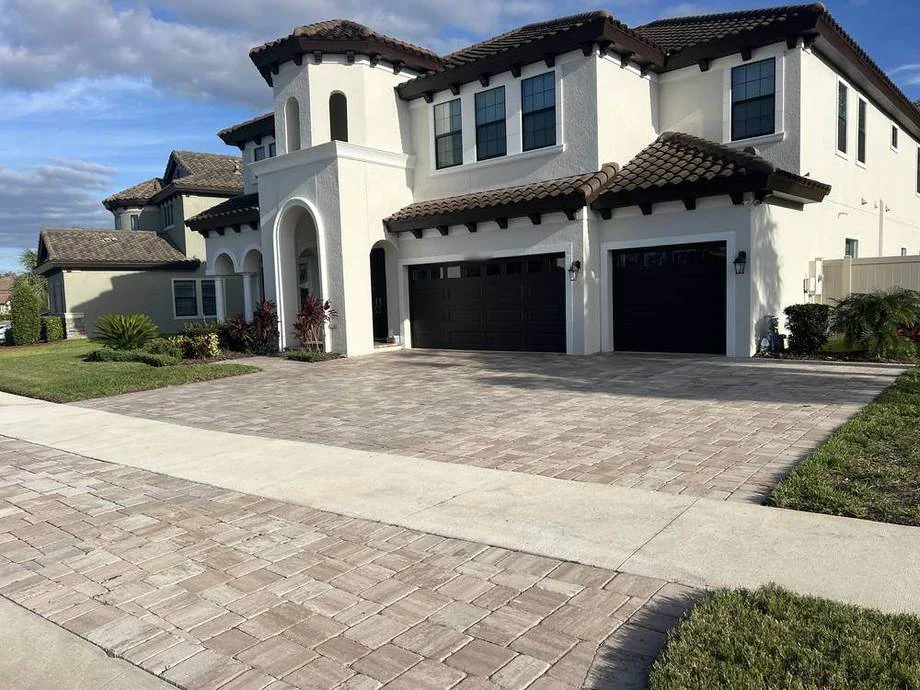 Paver driveway and walk in front of a white stucco home