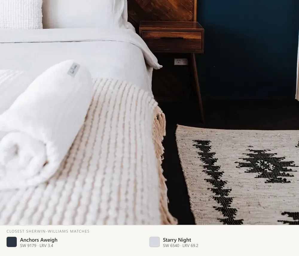 Deep navy behind a wood headboard