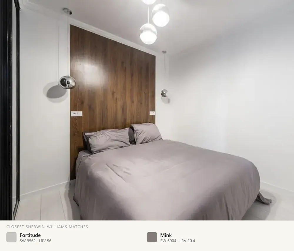 White bedroom with a wood accent