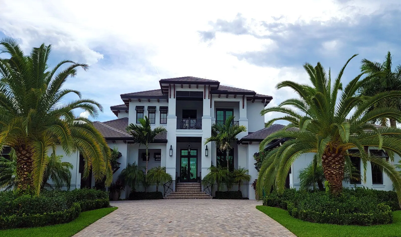 A coastal Florida estate with royal palms and a paver drive