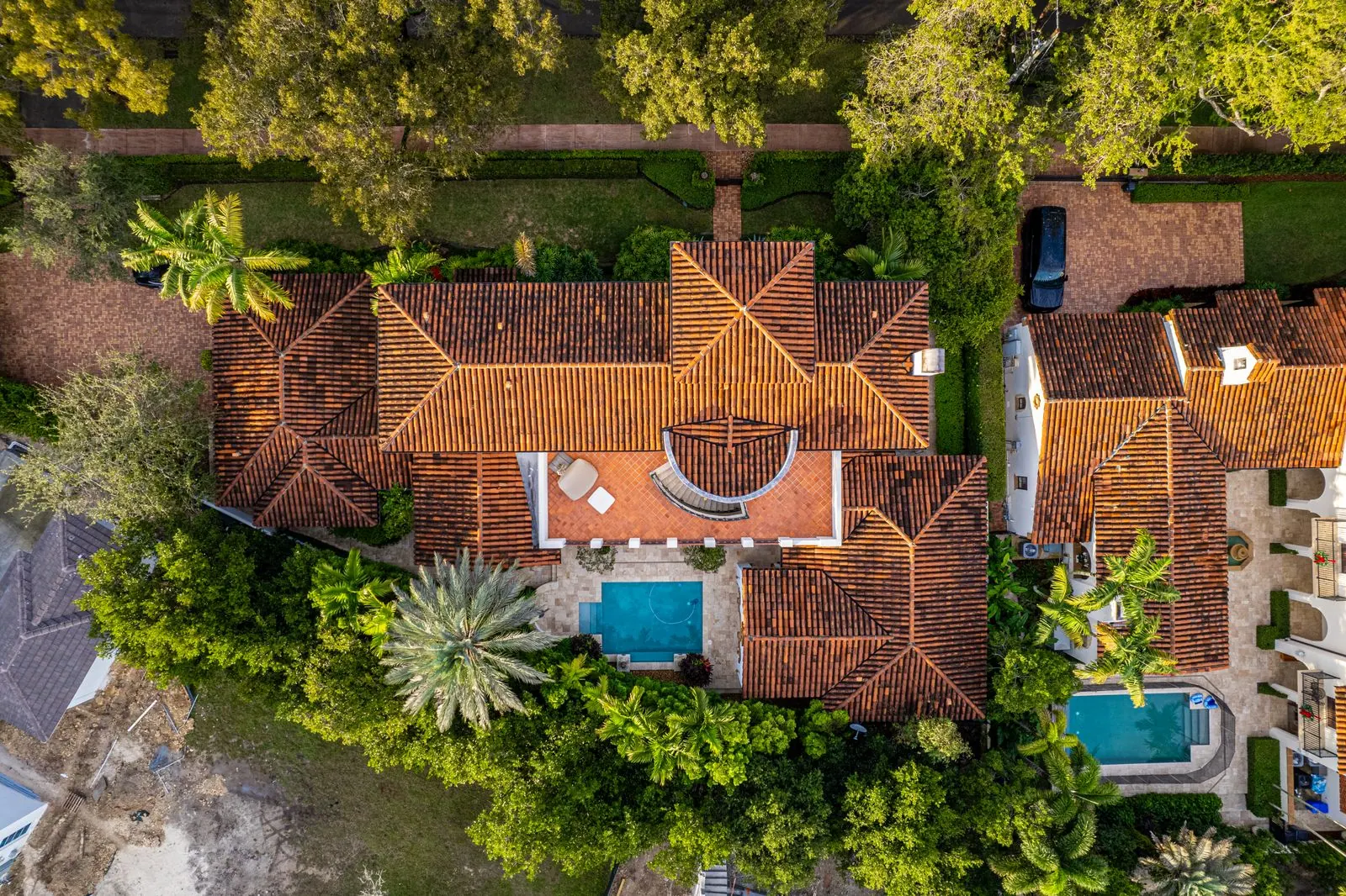 Aerial view of a Mediterranean home with terracotta roofs and a pool